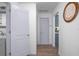 Hallway with white paint, wood-look floors, and white doors throughout the home at 267 Broad St, Brooksville, FL 34604