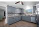 Updated kitchen features gray cabinetry, modern backsplash, and stainless-steel appliances at 267 Broad St, Brooksville, FL 34604