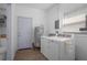Laundry room with washer, dryer, utility sink, and adjacent toilet at 267 Broad St, Brooksville, FL 34604