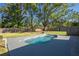 Private backyard featuring a sparkling in-ground pool and lush landscaping for ultimate relaxation at 267 Broad St, Brooksville, FL 34604