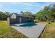 Backyard featuring a newly refinished pool, lush green grass, and privacy fence at 267 Broad St, Brooksville, FL 34604