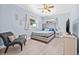 Bedroom featuring a tufted headboard, chair, and pale blue paint at 2861 Pinellas Point S Dr, St Petersburg, FL 33712