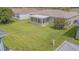 Expansive backyard features a screened-in lanai, lush lawn, and mature landscaping, perfect for outdoor enjoyment at 29436 Zeller Ave, San Antonio, FL 33576
