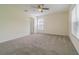 Neutral bedroom with a ceiling fan and a window for natural light at 29436 Zeller Ave, San Antonio, FL 33576