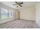 Bedroom with natural light, ceiling fan, neutral carpet and baseboards at 29436 Zeller Ave, San Antonio, FL 33576