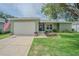 Charming single-story home featuring a well-maintained lawn and a two-car garage at 29436 Zeller Ave, San Antonio, FL 33576