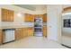 Bright kitchen features stainless steel appliances, oak cabinets, and tile flooring at 29436 Zeller Ave, San Antonio, FL 33576