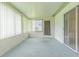 Cozy enclosed lanai featuring a sliding door, carpeted floor, and multiple windows at 29436 Zeller Ave, San Antonio, FL 33576