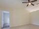 Open living room featuring neutral walls, tile flooring, and ceiling fan at 29436 Zeller Ave, San Antonio, FL 33576