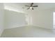Open living room featuring neutral walls, tile flooring, and two entries at 29436 Zeller Ave, San Antonio, FL 33576