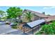 Auditorium entrance with covered walkway, palm trees, and landscaping and view of tennis courts in background at 2961 Briar Cliff Dr, Palm Harbor, FL 34684