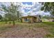 This backyard has mature trees and natural ground cover, and a view of a room addition at 2961 Briar Cliff Dr, Palm Harbor, FL 34684