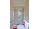 Bathroom featuring neutral walls, tile floor, toilet, grab bar, and shower with sliding glass doors at 2961 Briar Cliff Dr, Palm Harbor, FL 34684