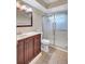 Updated bathroom featuring a modern vanity, mirror and a glass enclosed shower at 2961 Briar Cliff Dr, Palm Harbor, FL 34684