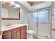 Updated bathroom featuring a modern vanity, mirror and a glass enclosed shower at 2961 Briar Cliff Dr, Palm Harbor, FL 34684
