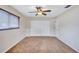 Bedroom featuring neutral walls, brown carpet, a ceiling fan, closet, and a window with mini blinds at 2961 Briar Cliff Dr, Palm Harbor, FL 34684