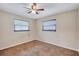 Bedroom featuring neutral colored walls, carpet, and two windows providing natural light at 2961 Briar Cliff Dr, Palm Harbor, FL 34684