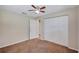 Bedroom with neutral walls, brown carpet, ceiling fan, standard closet, and ensuite access at 2961 Briar Cliff Dr, Palm Harbor, FL 34684