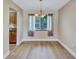 Bright dining area featuring wood floors and a window bringing in natural light at 2961 Briar Cliff Dr, Palm Harbor, FL 34684