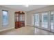 Bright dining room with large windows and access to outdoor lanai through glass doors at 2961 Briar Cliff Dr, Palm Harbor, FL 34684