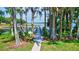Dock view with access to the lake surrounded by trees at 2961 Briar Cliff Dr, Palm Harbor, FL 34684