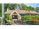 Image of the Lake Tarpon Lodge with lush tropical plants and manicured landscaping at 2961 Briar Cliff Dr, Palm Harbor, FL 34684