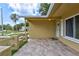 This home has a covered entrance with a tiled front porch and a side view of the front yard at 2961 Briar Cliff Dr, Palm Harbor, FL 34684