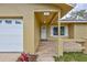 Charming home featuring a covered front entrance with tiled flooring and a well-maintained landscape at 2961 Briar Cliff Dr, Palm Harbor, FL 34684