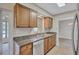 Bright kitchen with granite countertops, stainless steel appliances, and wooden cabinets at 2961 Briar Cliff Dr, Palm Harbor, FL 34684