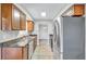 Galley kitchen featuring sleek stainless steel appliances, granite countertops, and tile flooring at 2961 Briar Cliff Dr, Palm Harbor, FL 34684