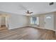 Bright living room features modern wood flooring, ceiling fan and a window providing natural light at 2961 Briar Cliff Dr, Palm Harbor, FL 34684