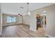 Living room with wood flooring leads to an open kitchen and dining area, all with natural light at 2961 Briar Cliff Dr, Palm Harbor, FL 34684