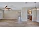Open-concept living room boasts wood floors with views into kitchen with stainless appliances at 2961 Briar Cliff Dr, Palm Harbor, FL 34684