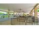Exterior patio with covered structure including fans, tables, and seating at 2961 Briar Cliff Dr, Palm Harbor, FL 34684