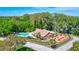 Aerial view of community pool and picnic area with lush landscaping and trees at 2961 Briar Cliff Dr, Palm Harbor, FL 34684