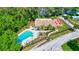 Aerial view of community pool with plenty of seating and beautiful trees at 2961 Briar Cliff Dr, Palm Harbor, FL 34684