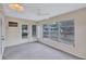 Bright sunroom featuring neutral walls, carpet, ceiling fan, and abundant natural light from large windows at 2961 Briar Cliff Dr, Palm Harbor, FL 34684