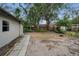 A lush backyard offering potential for gardening and outdoor activities with mature trees at 306 S Highland Ave, Clearwater, FL 33755