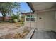 View of backyard showing a well maintained shed, a patio, and tree coverage at 306 S Highland Ave, Clearwater, FL 33755