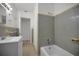 A well-kept bathroom featuring a tub and shower combination, along with classic tiled walls at 306 S Highland Ave, Clearwater, FL 33755