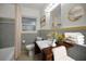 Bathroom with a bathtub, toilet, sink, and vanity, enhanced with flowers, towels, and a wood accent tray at 306 S Highland Ave, Clearwater, FL 33755