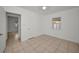 Inviting bedroom with neutral paint, tile flooring, and a door leading to the rest of the house at 306 S Highland Ave, Clearwater, FL 33755