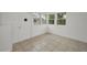Bonus room features white walls, tile flooring, and windows allowing natural light to brighten up the room at 306 S Highland Ave, Clearwater, FL 33755