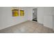 Bonus room featuring bright, white walls, tile flooring, and a view to another room in the home at 306 S Highland Ave, Clearwater, FL 33755