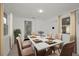 Bright dining area featuring seating for six around a marble table with decor and neutral accents at 306 S Highland Ave, Clearwater, FL 33755