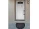 Close-up of a modern white front door with secure lockbox at 306 S Highland Ave, Clearwater, FL 33755