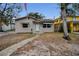 Inviting single-story home with awnings and a walkway leads to a decorative door frame at 306 S Highland Ave, Clearwater, FL 33755