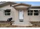 Charming front porch with decorative wrought iron pillars framing a modern, white door at 306 S Highland Ave, Clearwater, FL 33755