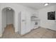 Bright kitchen features white appliances, tiled floor, and ample counter space with a door leading outside at 306 S Highland Ave, Clearwater, FL 33755