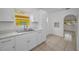 Modern kitchen featuring bright cabinetry, a stainless steel sink, and natural light coming through a window at 306 S Highland Ave, Clearwater, FL 33755